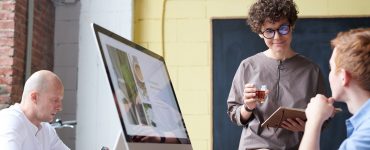 man in blue collared top using imac indoors 3182782